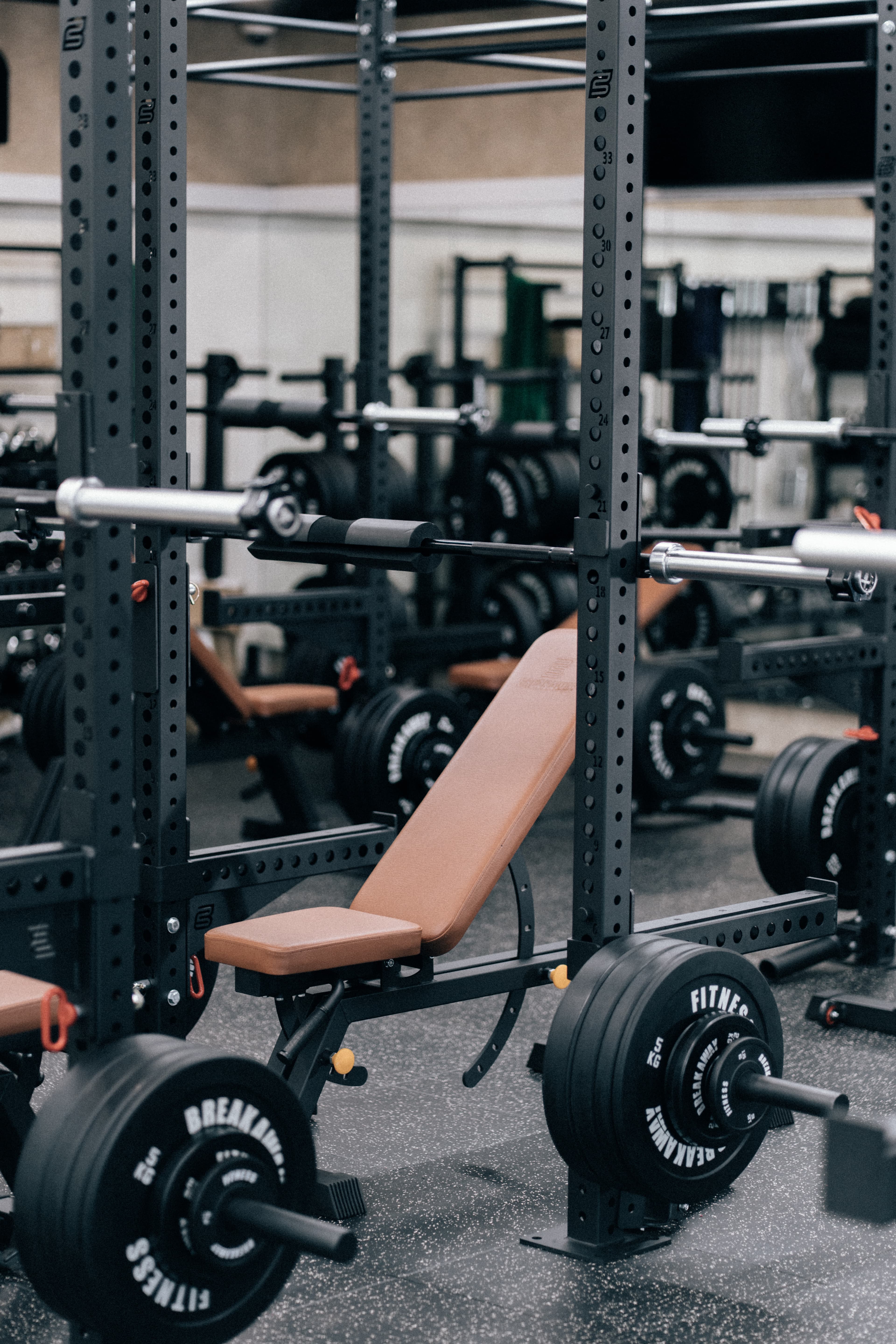 Gym equipment setup with power rack and weights